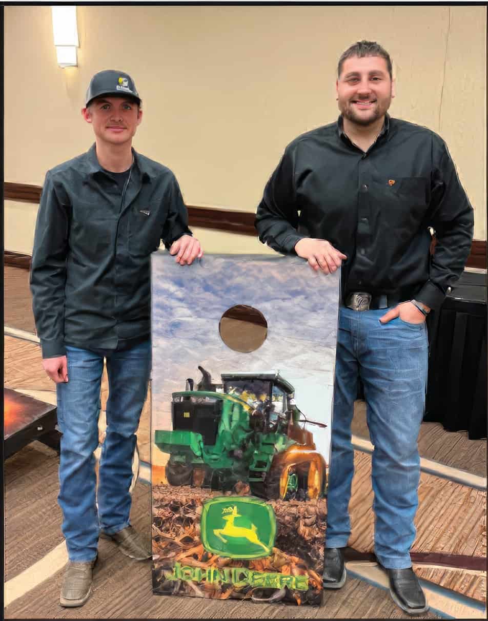 Aftermarket Top Performers standing with John Deere corn hole board