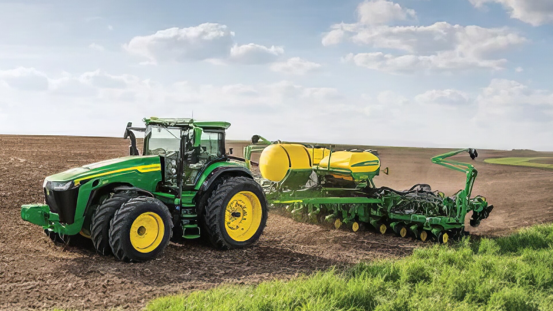 green tractor planting in field