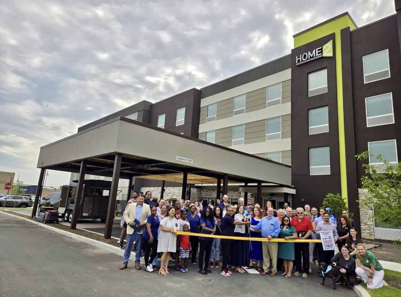 Brandt Hospitality Group and Homes2 Suites Poughkeepsie managers at the ribbon cutting for the hotel (zoomed out photo of the entire group of people).