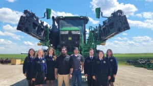 Minnesota FFA Foundation at Kibble Equipment in front of a John Deere tractor/implement
