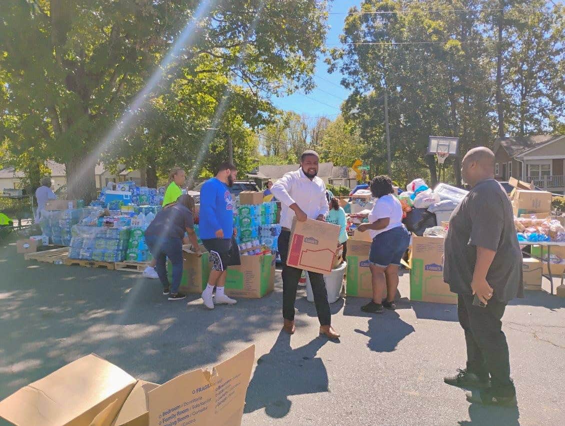 BHG individuals helping distribute boxes of supplies outside